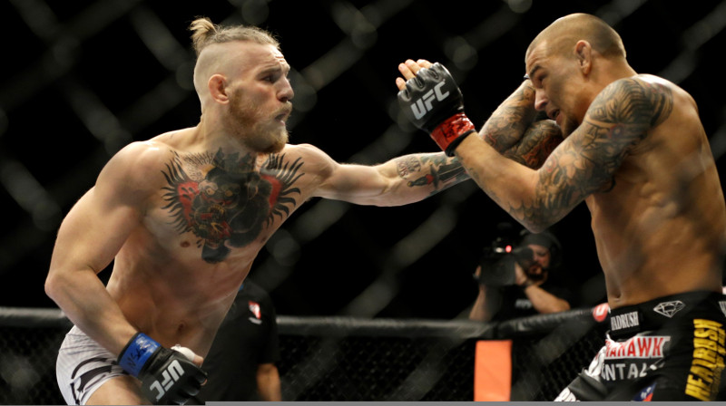 Konors Makgregors (pa kreisi) un Dastins Porjē abu pirmajā duelī 2014. gadā. Foto: AP/Scanpix