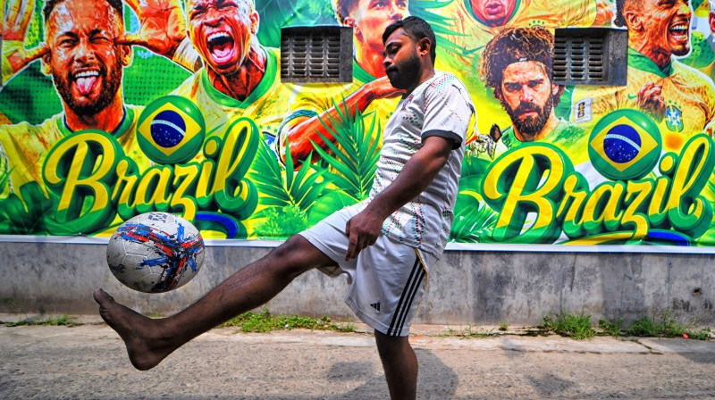 Kolkata, Indija. Futbols tiek spēlēts blakus Brazīlijas izlases tematikā krāsotai sienai. Foto: Zumapress/Scanpix
